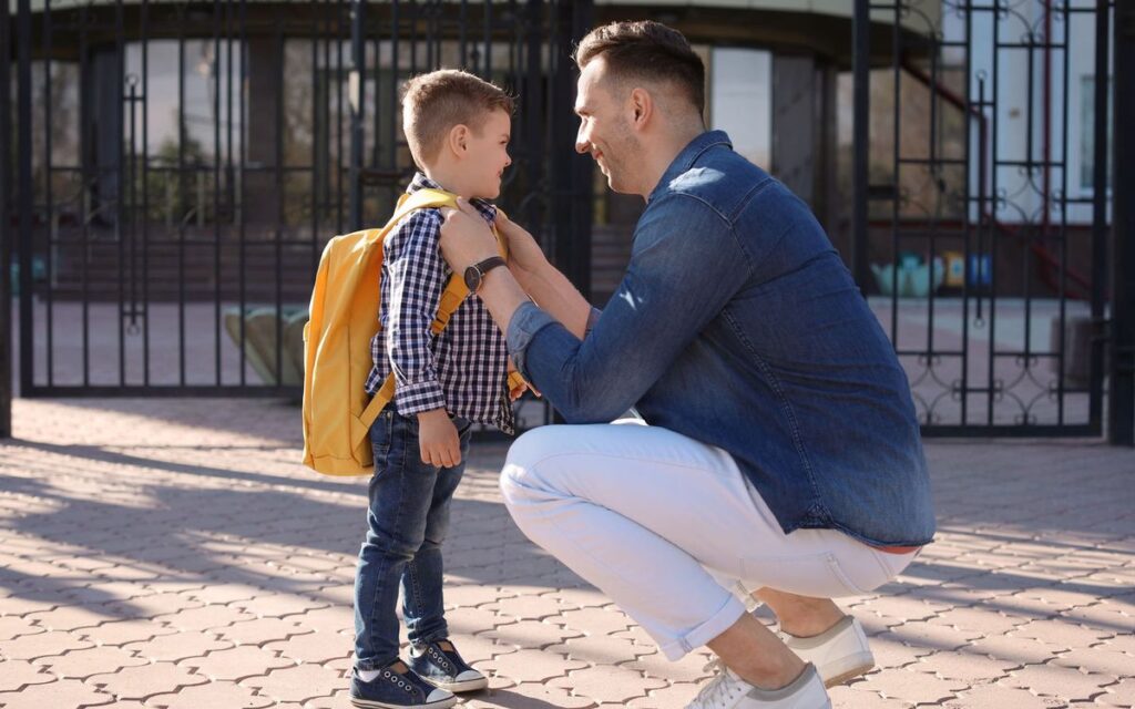 goodbye time between dad and son after seeing him off to school