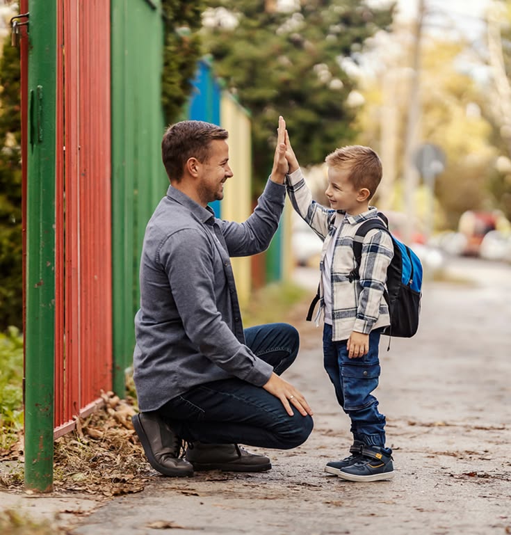 dad and son doing their morning hand shake before school