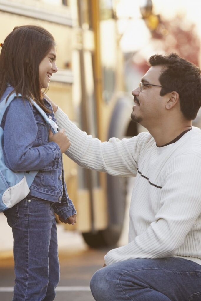 father seeing his daughter off to school to ease first day of school anxiety