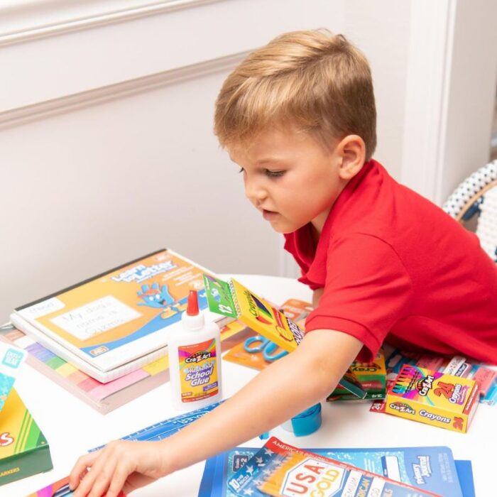 a kid arranging his school items