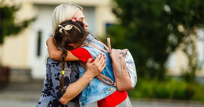 mom hugging her child to reduce first-day of school anxiety