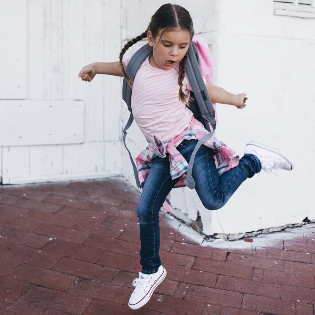 school kid jumps in excitement 