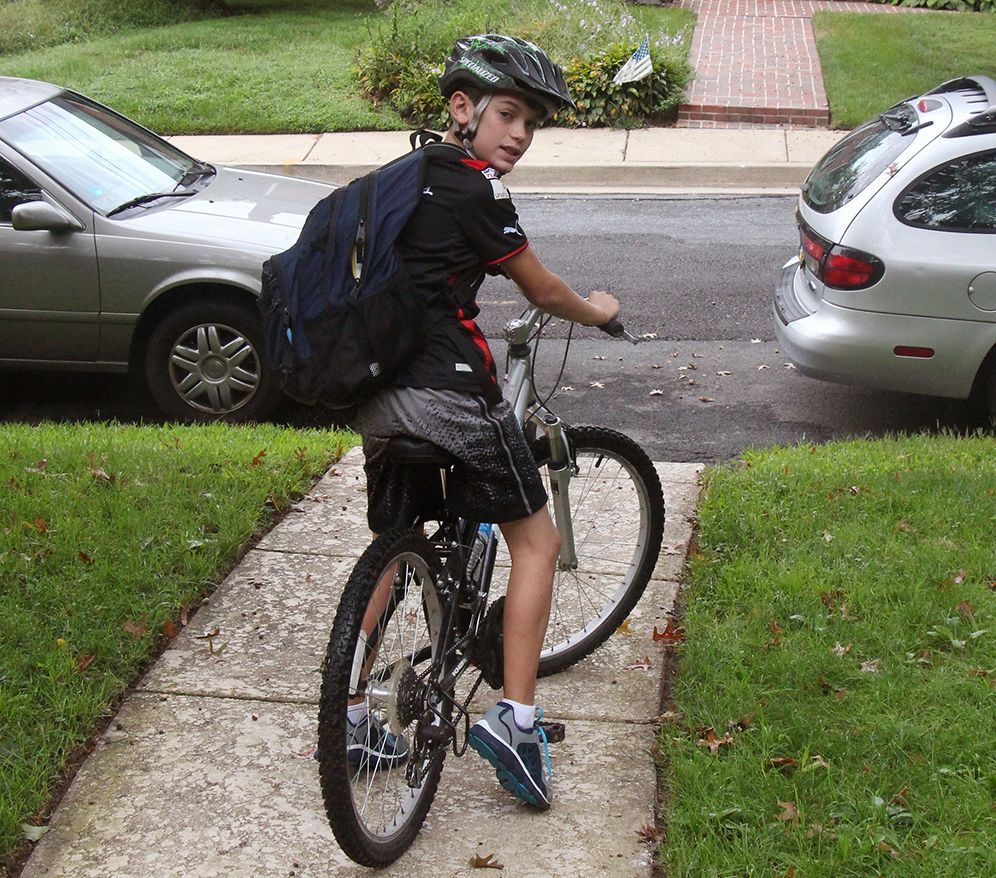 kid riding bike to school