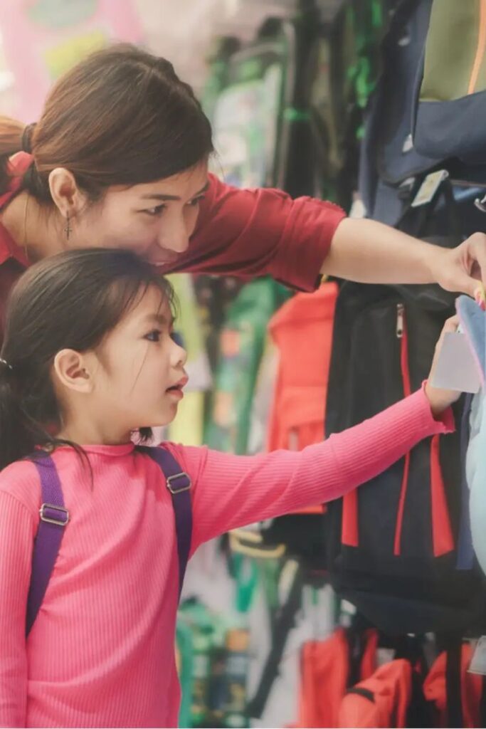 kid and mom shopping backpack as  transition back to school tips