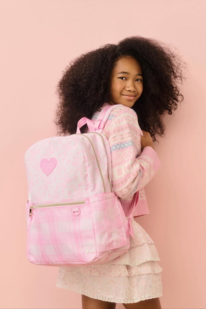 a kid trying her backpack out