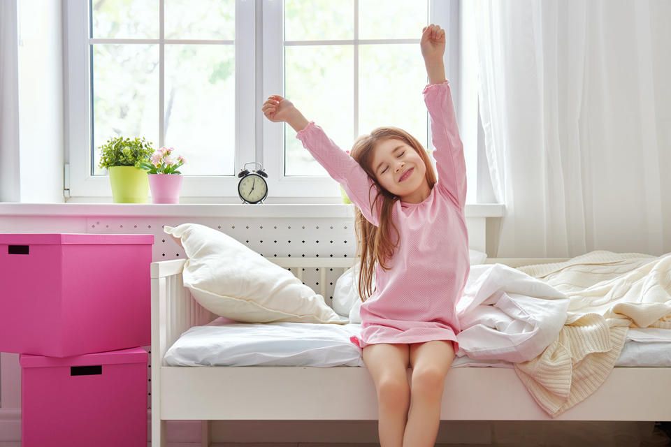 kid waking up on time as part of transition back to school tips