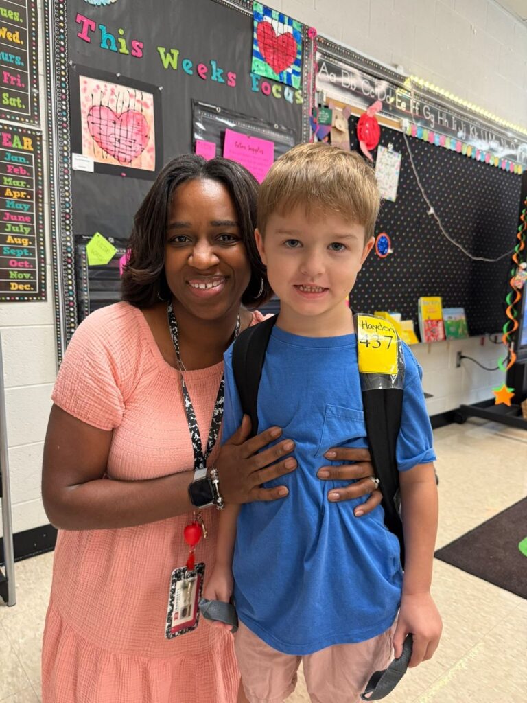 photo of school kid with his teacher