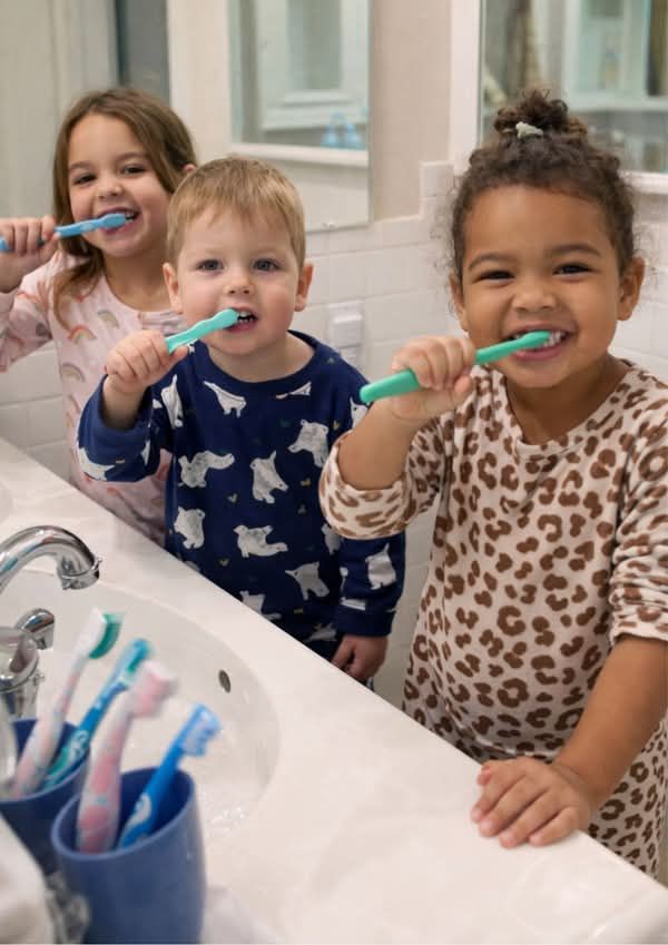 kids brushing their teeth as part of the easy transition back to school tips