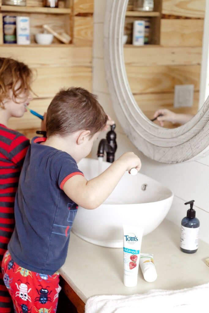 two kids brushing their teeth to practice a preparation for the first day of school
