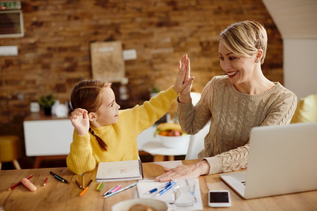 mom and kid doing home work happily