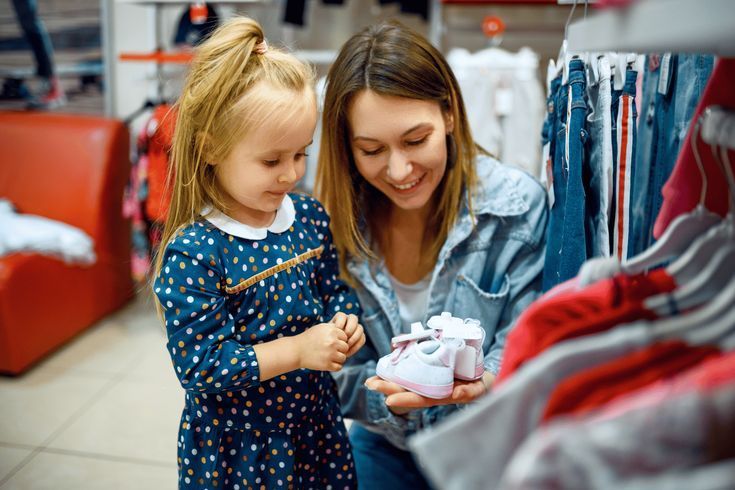 mom and kid shopping school shoe together to avoid back to school shopping mistake