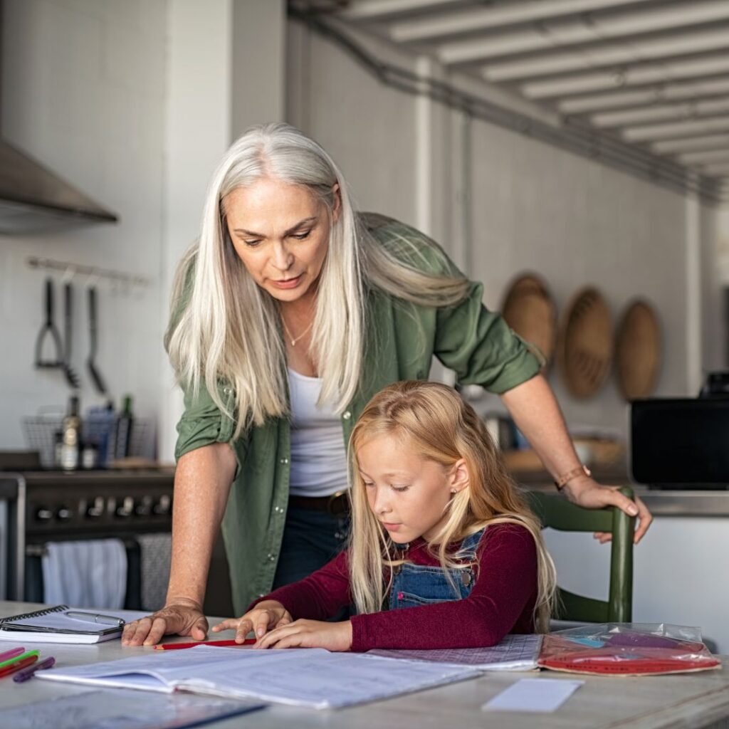 mom assisting her child with her homework