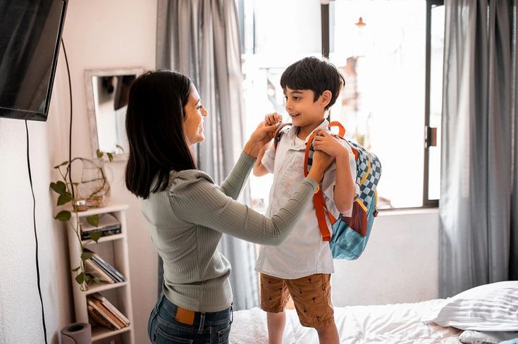 mom dressing kid up for school