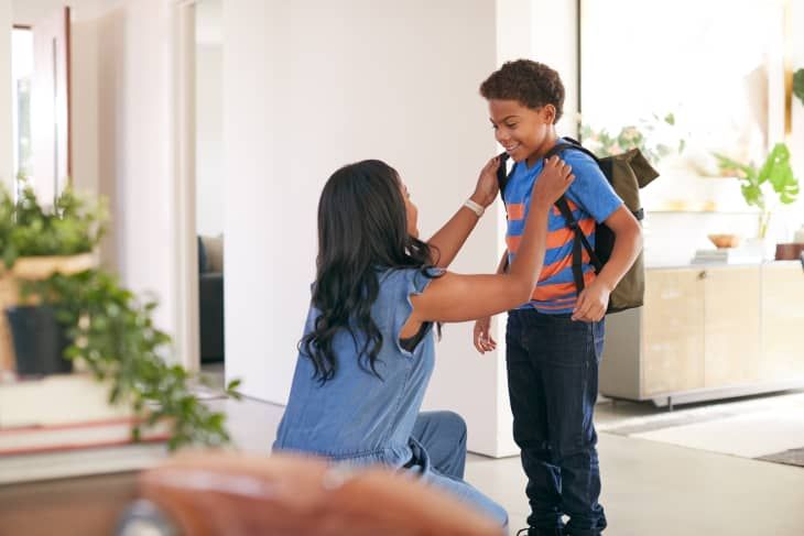 a mother preparing her son for school as part of school morning routine