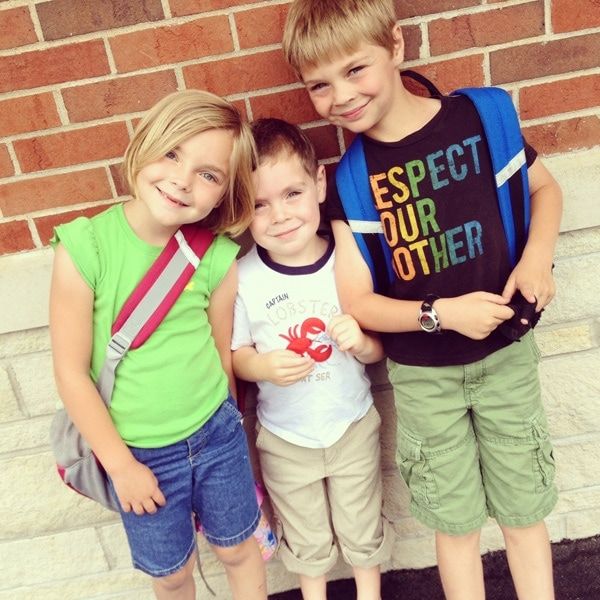 school kids taking siblings picture together as first day of school photo idea