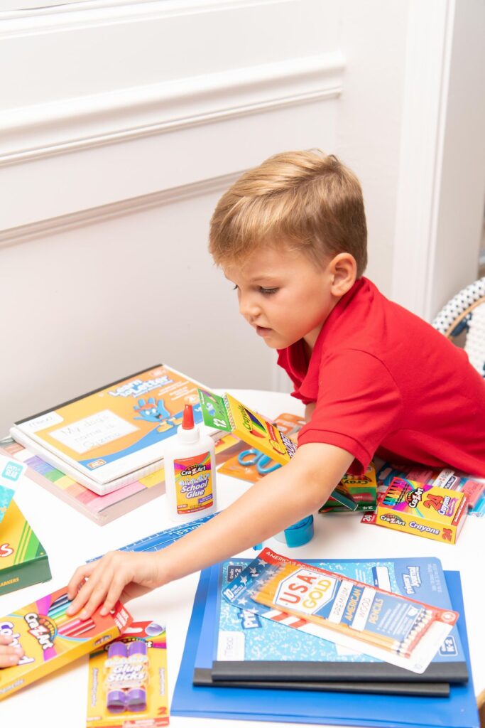 a child arranging his go back to school things for the first day of school