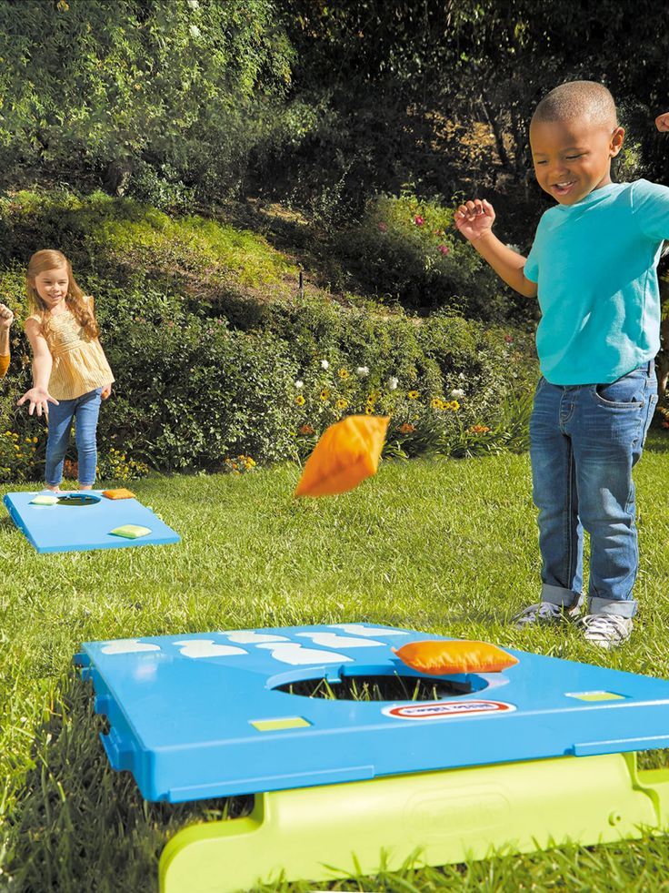 kids playing cornhole as one of the fun fall activities for kids