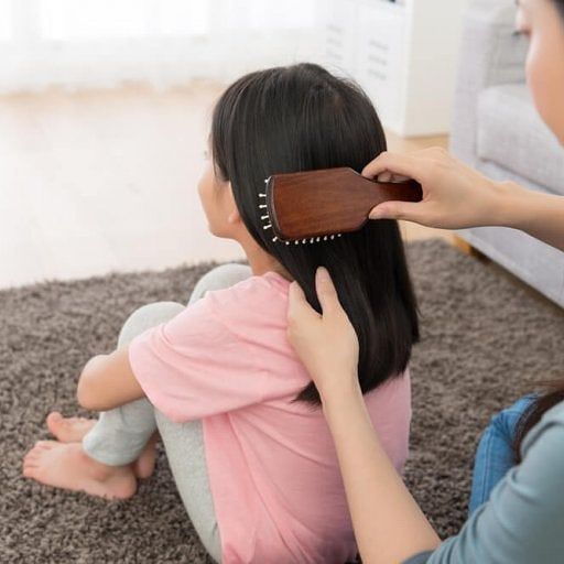 mom brushing her kid's hair