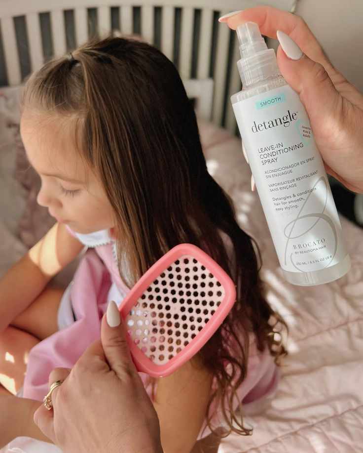 mom detangling kid's hair