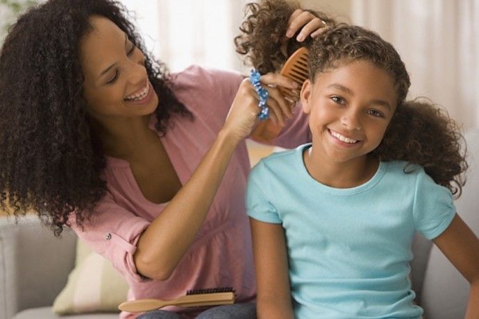 mom styling kid's hair
