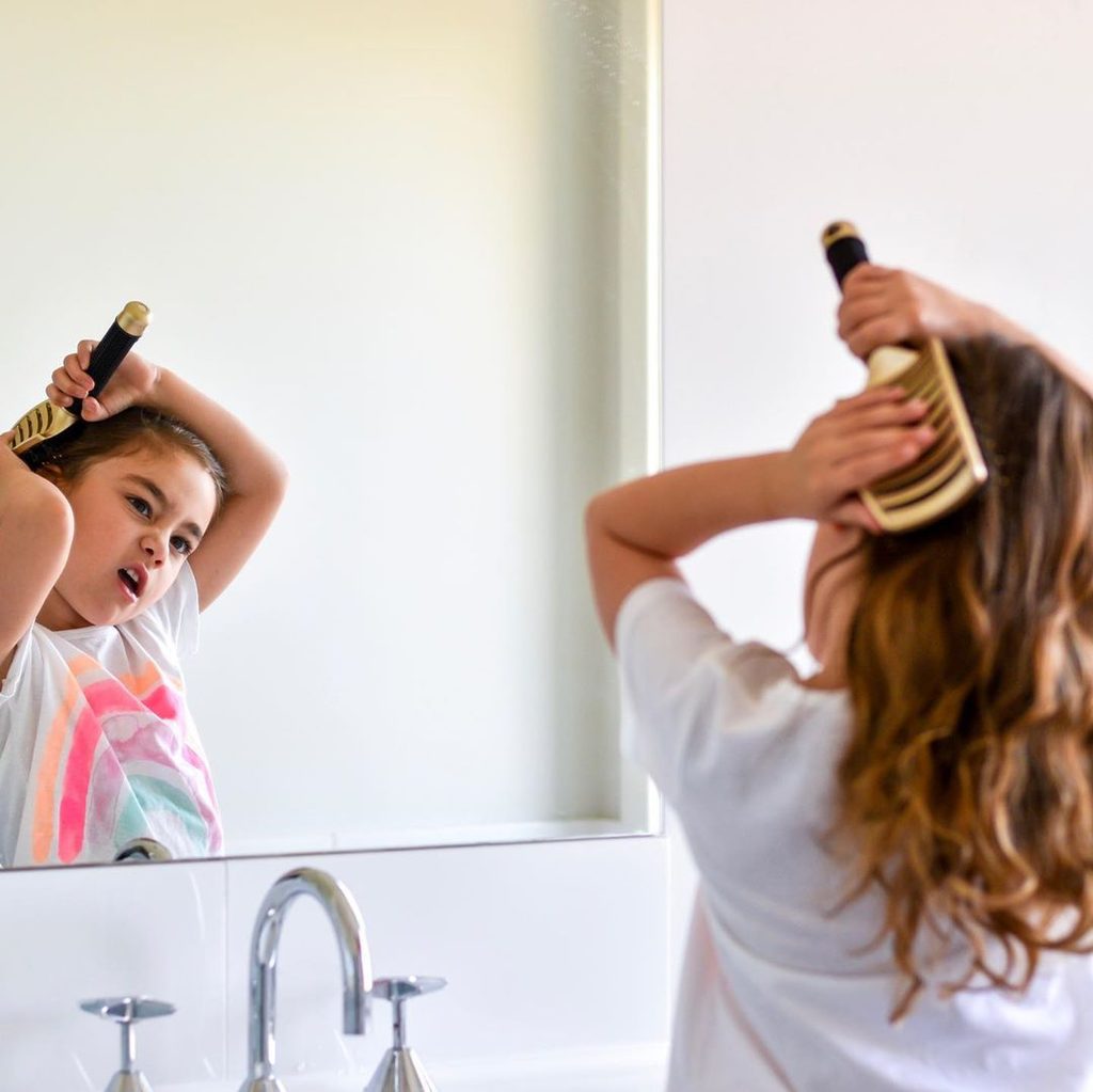 kid brushing her hair
