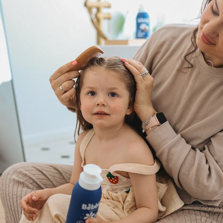 mom caring for her kids' hair