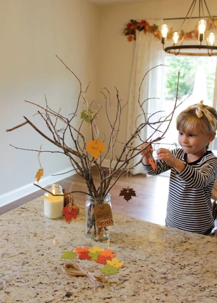 kid setting up gratitude tree