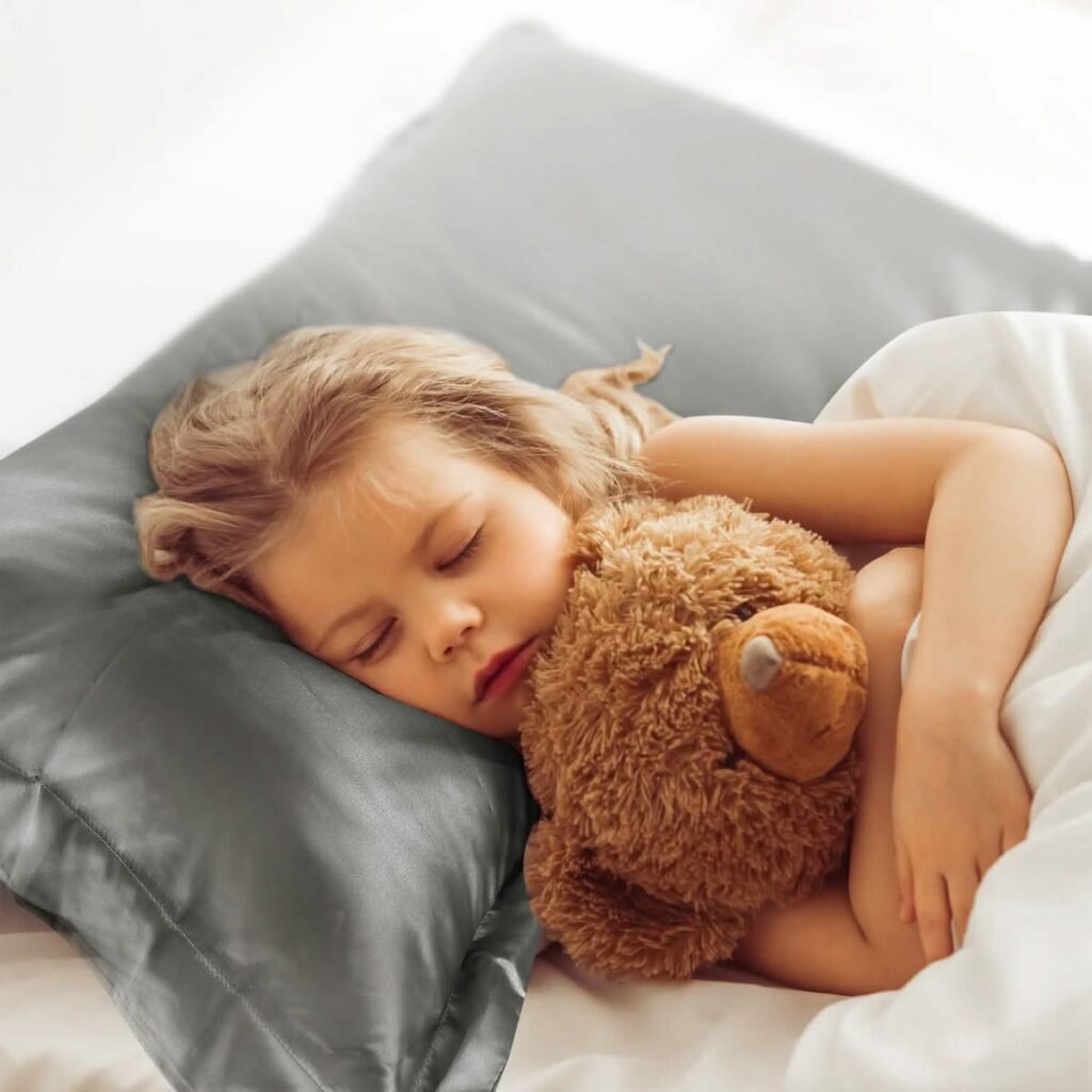 a kid sleeping on a silk pillowcase as a way to protect kid's hair while they sleep