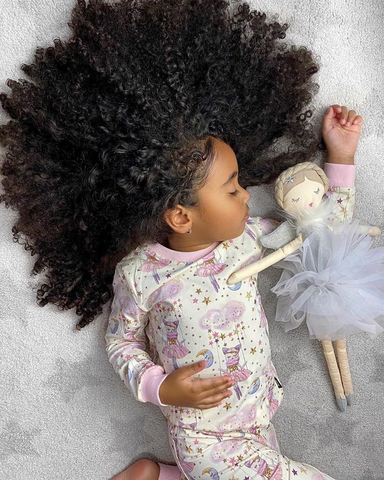 kid with a full hair sleeping
