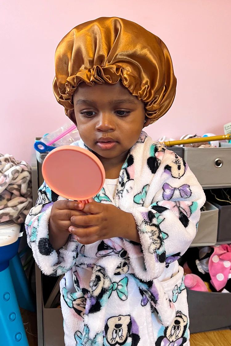 kid with hair bonnet