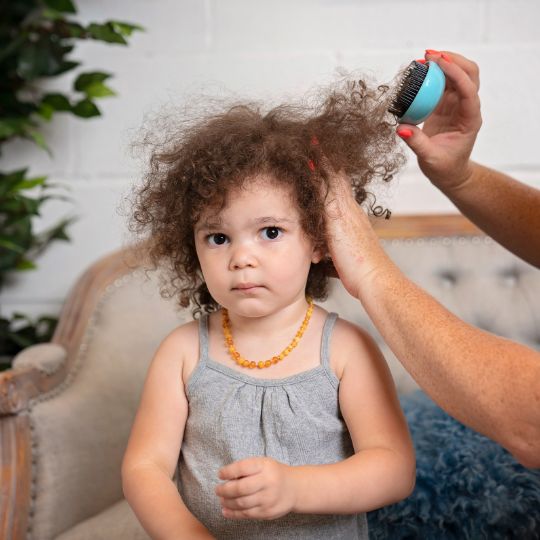 mom brushing her kid's hair