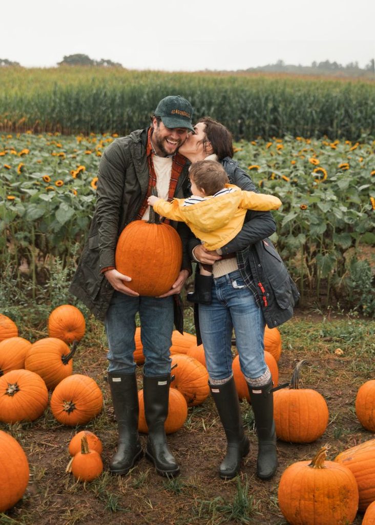 parents and their kid on pumpkin patch day