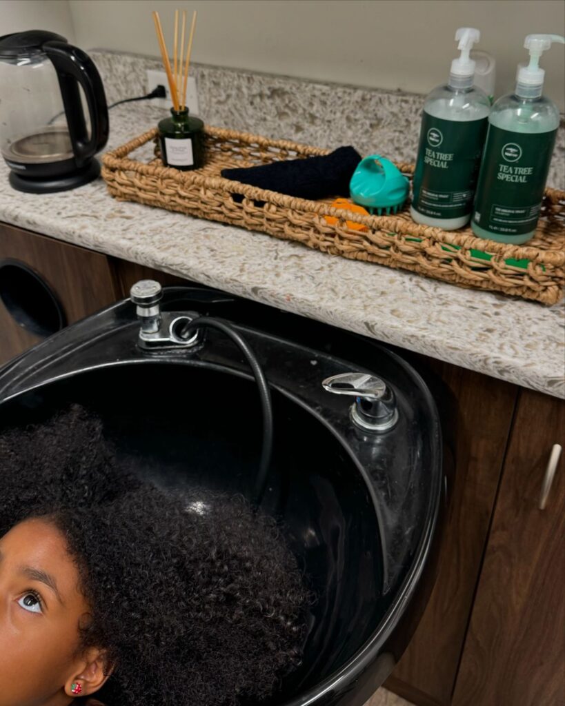 kid about to get her curly hair wash showing how to wash your child's hair