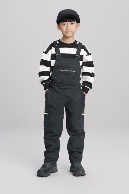 kid in basic overalls with a long sleeve top as casual outfit ideas for kids