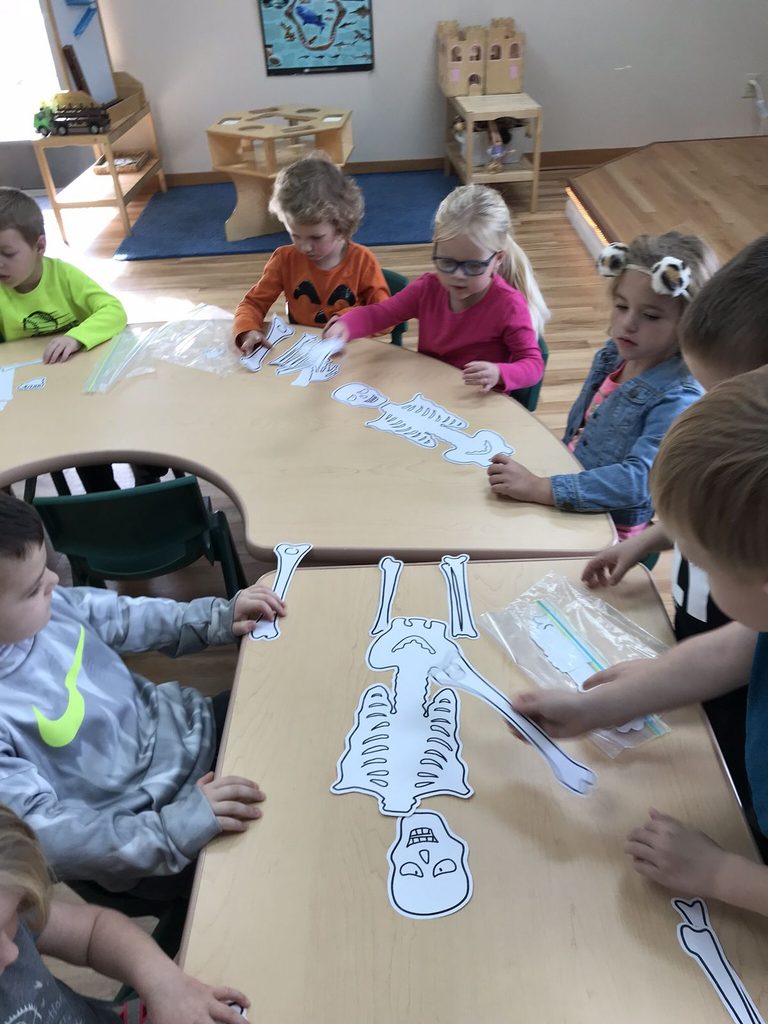kids solving skeleton puzzle