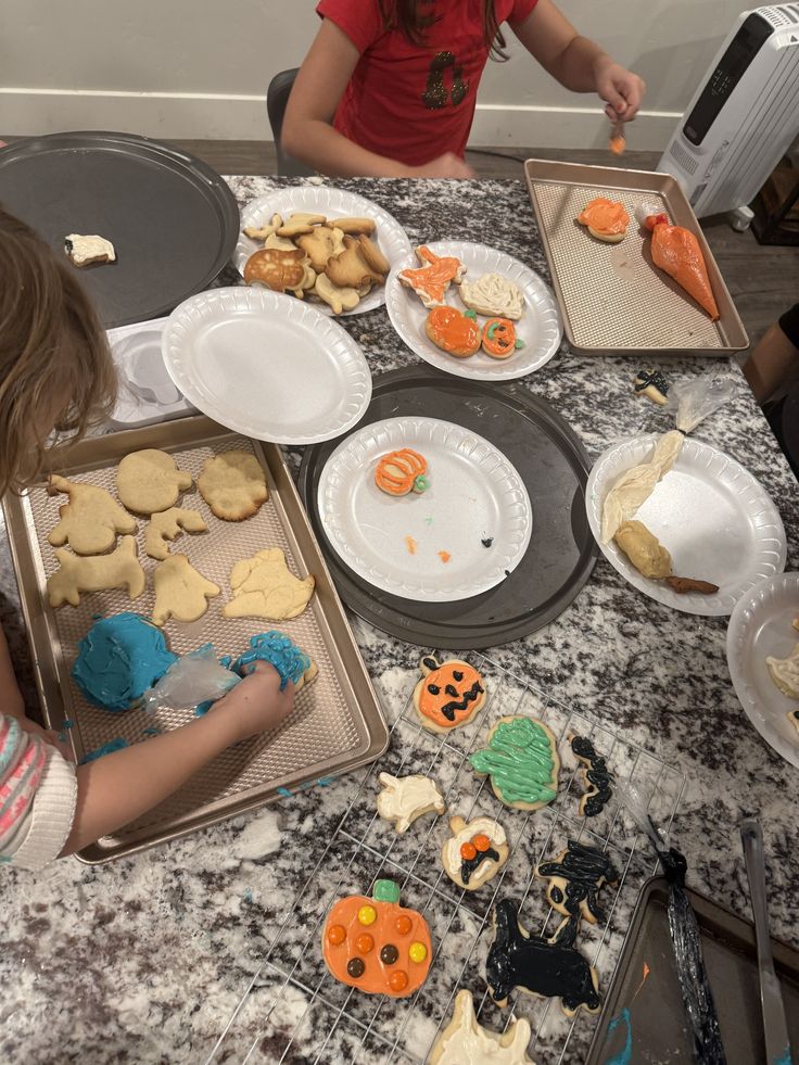kids decorating halloween cookies
