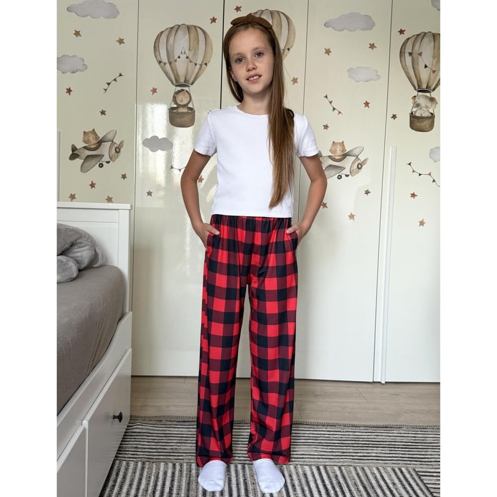 kid in flannel pajama pants with a plain tee as everyday outfits for kids