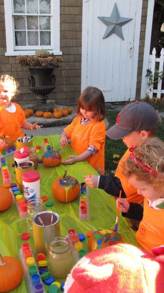 kids painting pumpkin as halloween activities for kids who don't like being scared