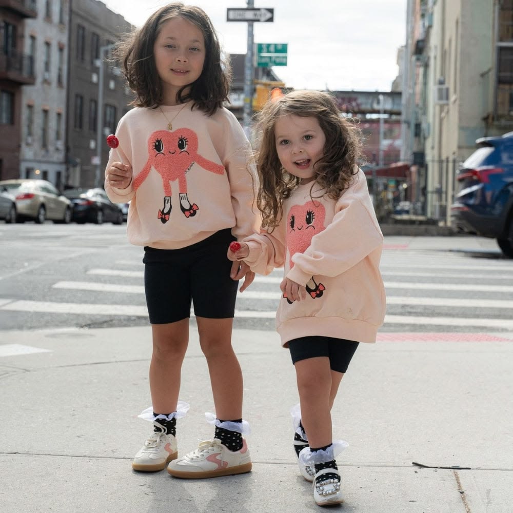 kids in graphic sweatshirt with bike shorts
