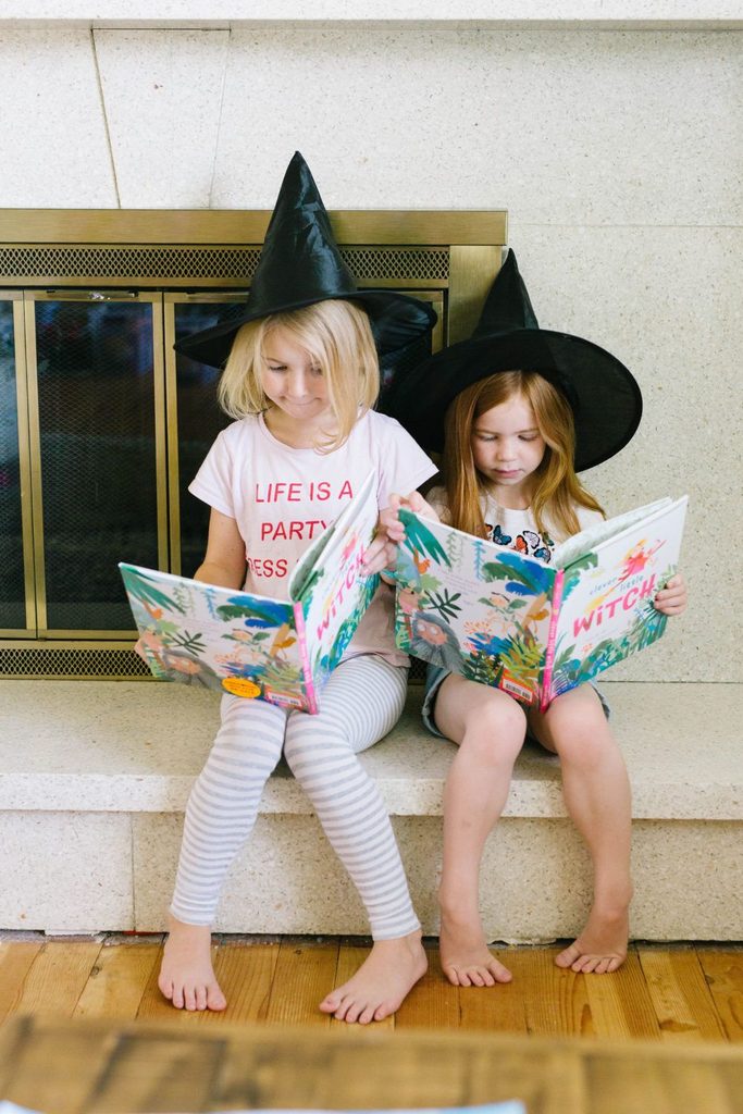 kids reading halloween book as one of the halloween activities for kids who don't like being scared