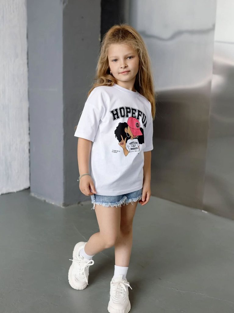 kid in jeans shorts with graphic Tee