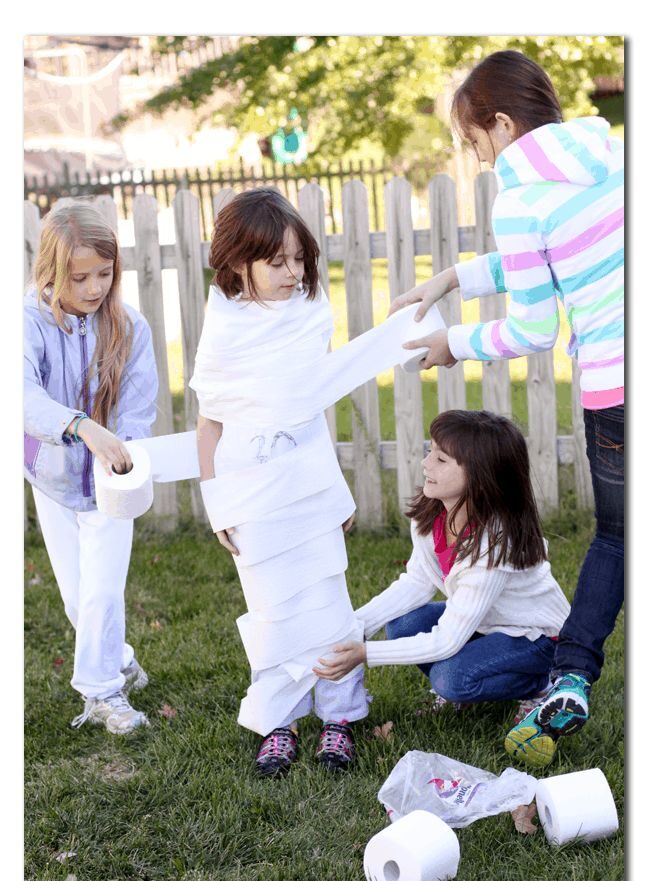 kids playing mummy wrap relay game as one of halloween games for kids