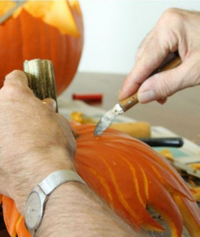 someone carving pumpkin