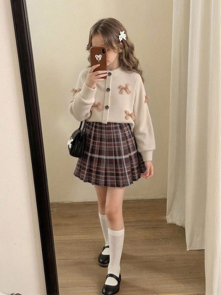 kid in plaid skirts in muted tone as trendy outfits for girls