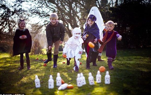 kids playing pumpkin bowling with pumpkin as one of halloween school party ideas