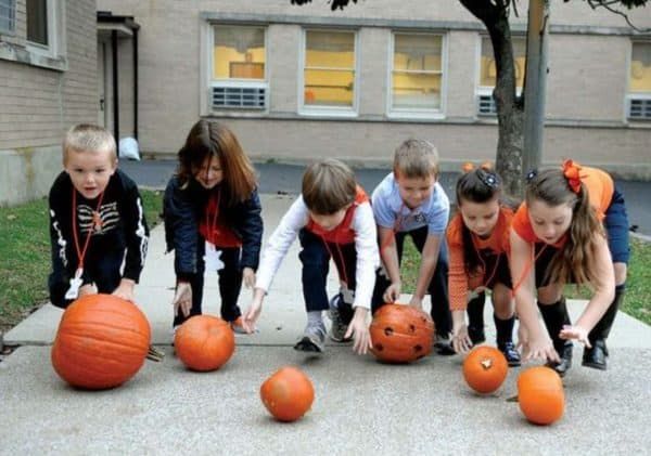 kids on pumpkin roll race