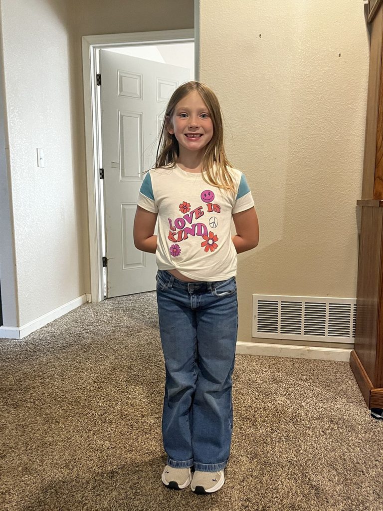 kid in straight leg jeans with a Tee as jeans outfit ideas for little girls