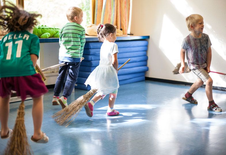 kids playing witches broom relay