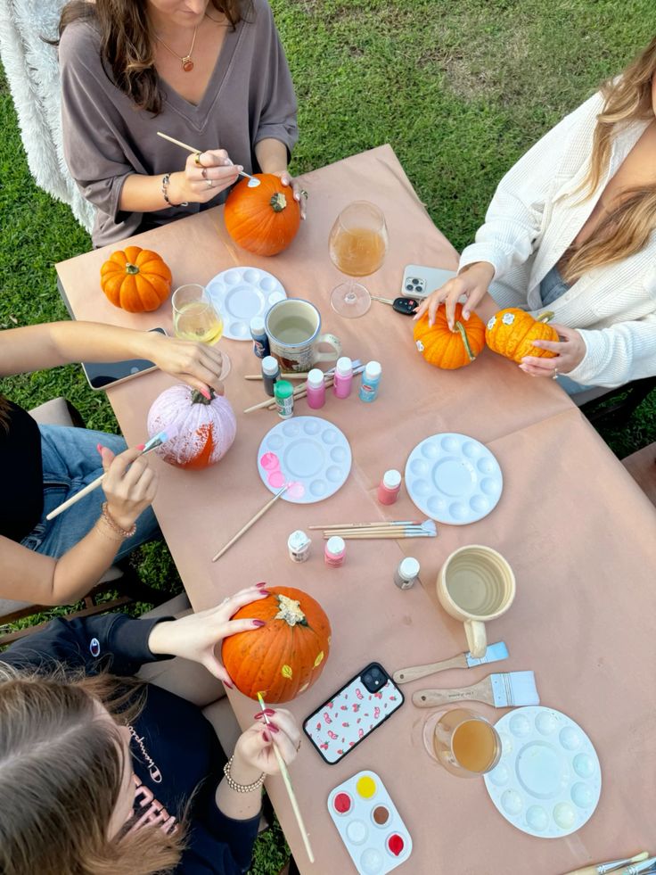 teens painting pumpkins