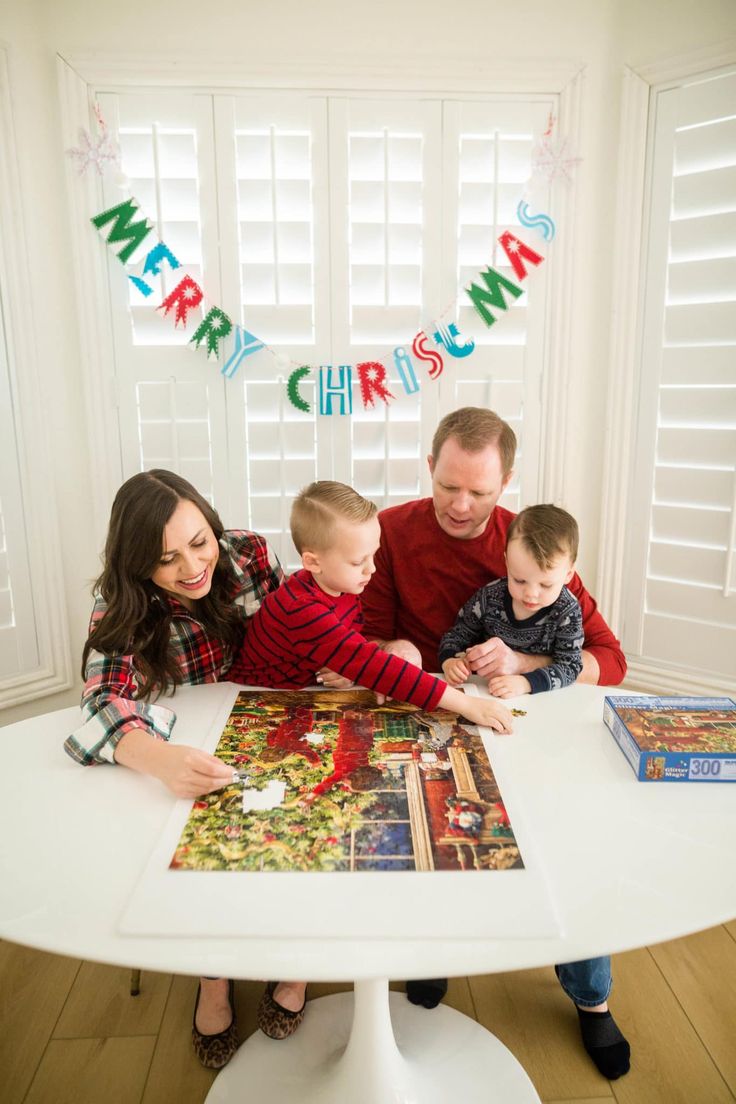 family playing christmas puzzle